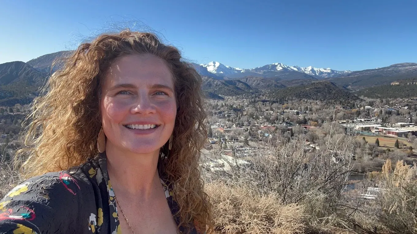 Joanna Maguire, founder of Live Well Durango, with the Durango, Colorado landscape behind her.