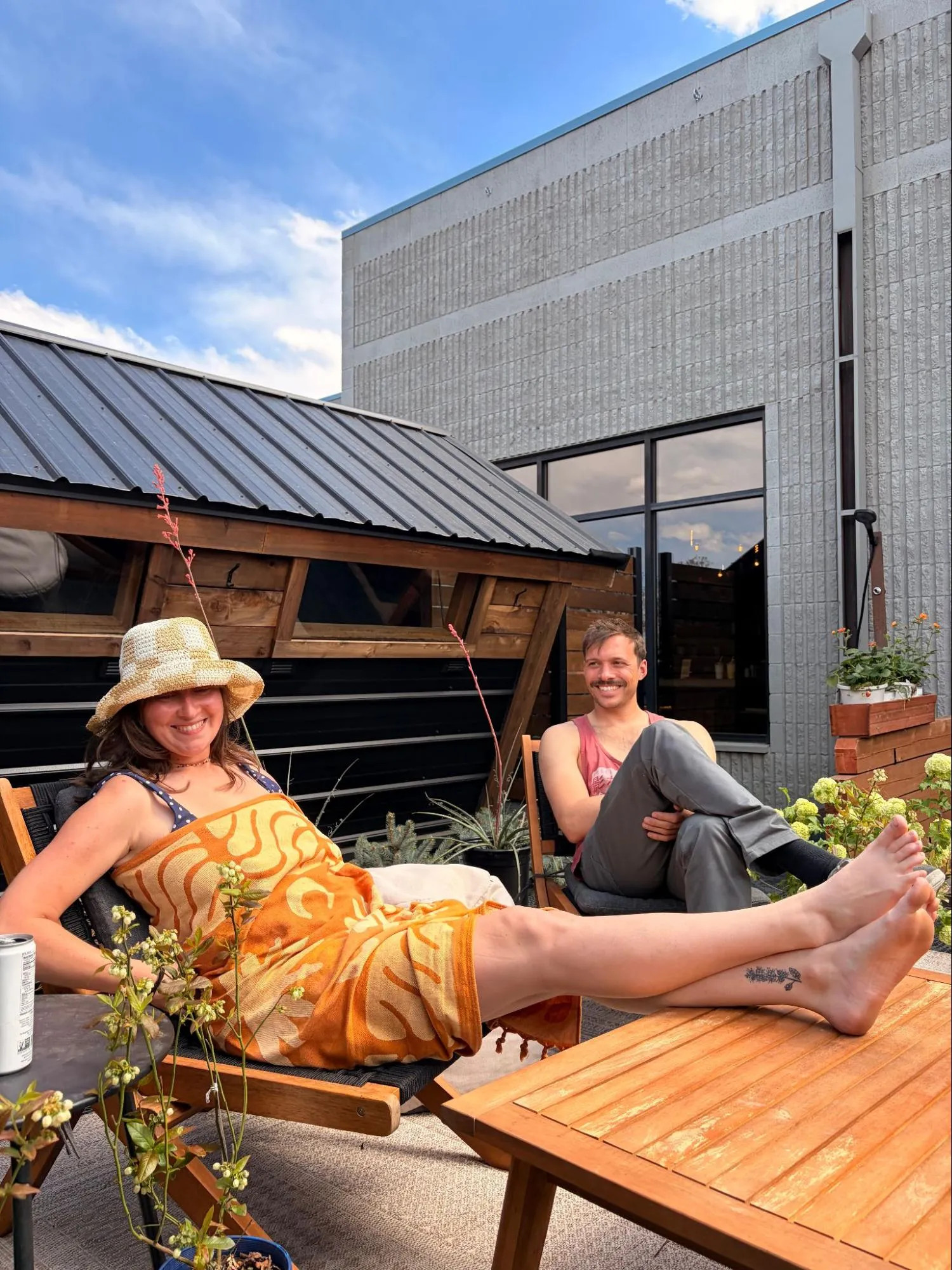 Two members relaxing on the outdoor deck at Third Space & Co.