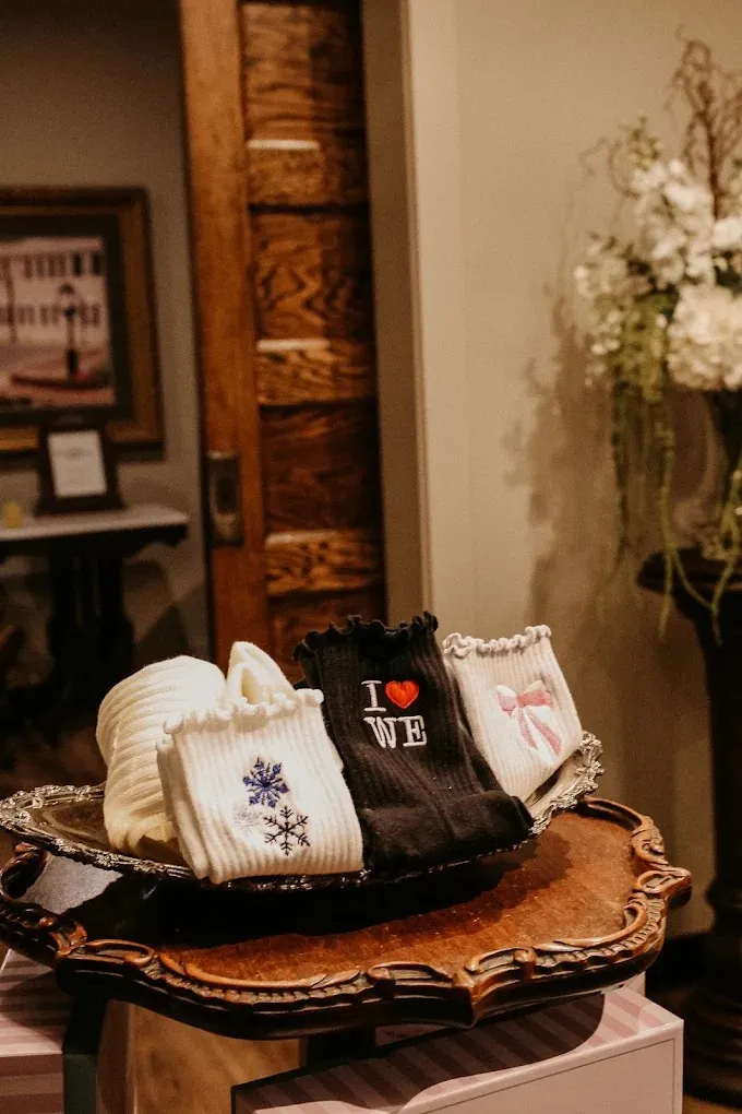 Embroidered grip socks displayed on a silver tray at the front of the studio.