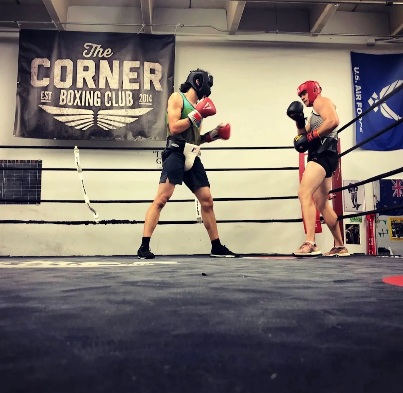 Two members sparring in the ring at The Corner Boxing Club