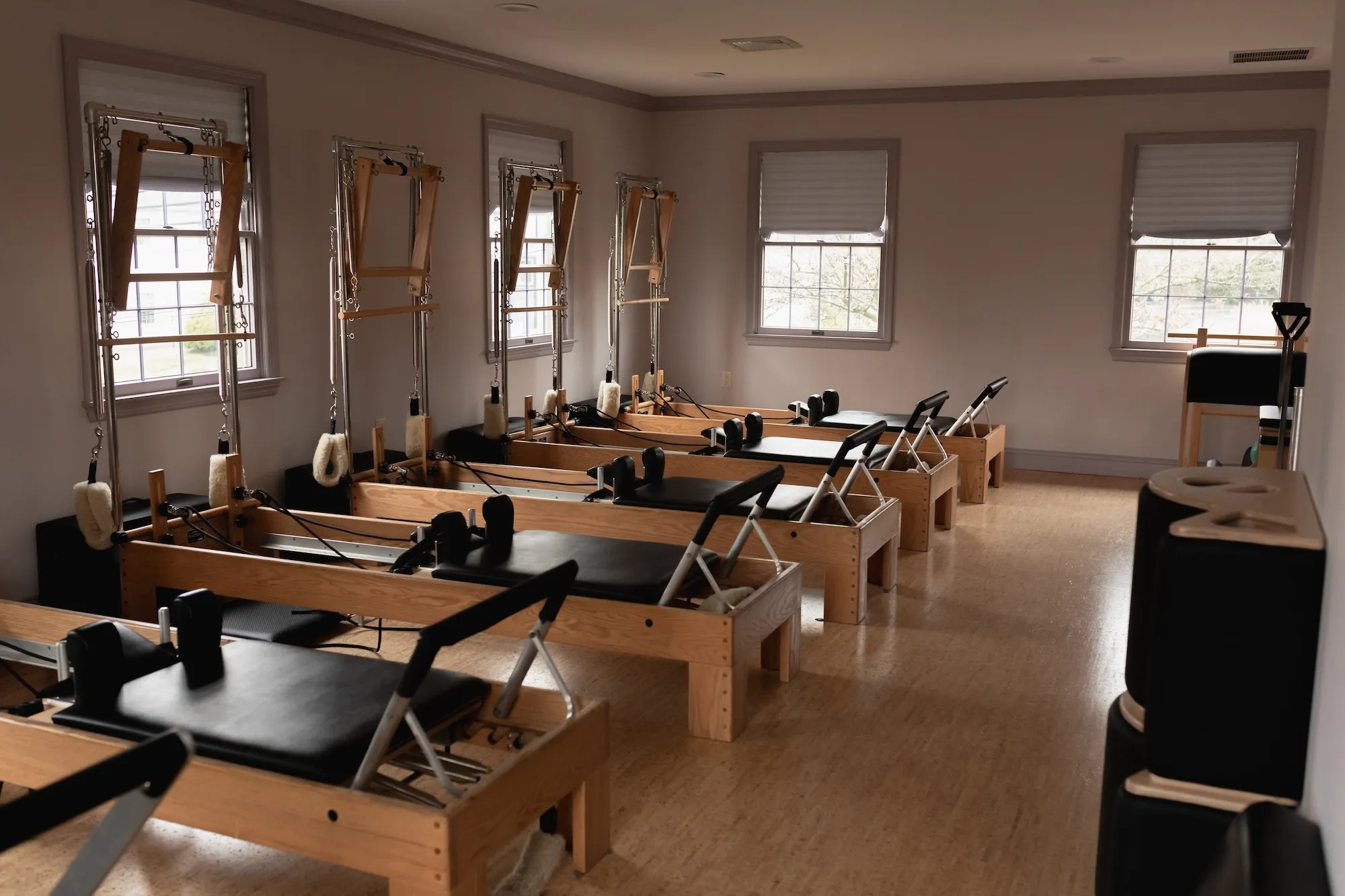 Reformers lined up inside a CS Fit Pilates studio
